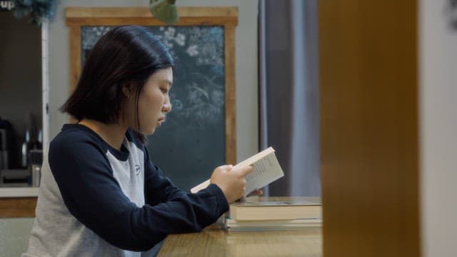 Young woman reading a book indoors