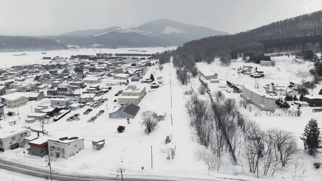 Snow-covered town with distant mountains
