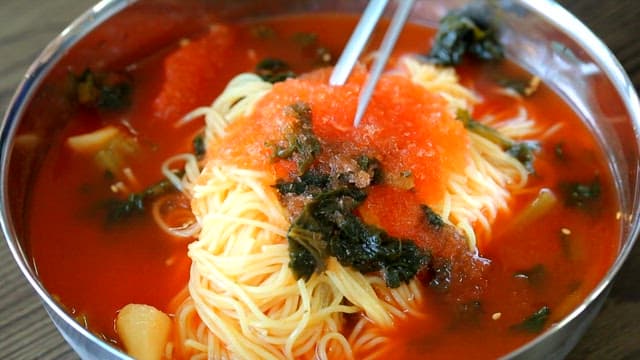 Stirring yeolmu noodles with chopsticks