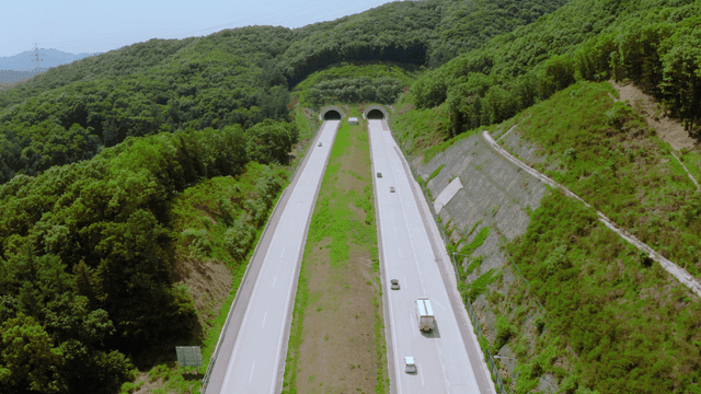 A highway cutting through lush green forests