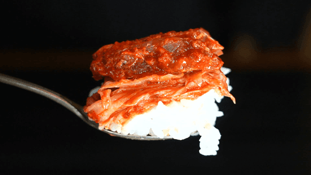 Kimchi on rice in a spoon