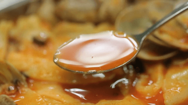 Spoonful of spicy noodles and hand-pulled dough soup broth