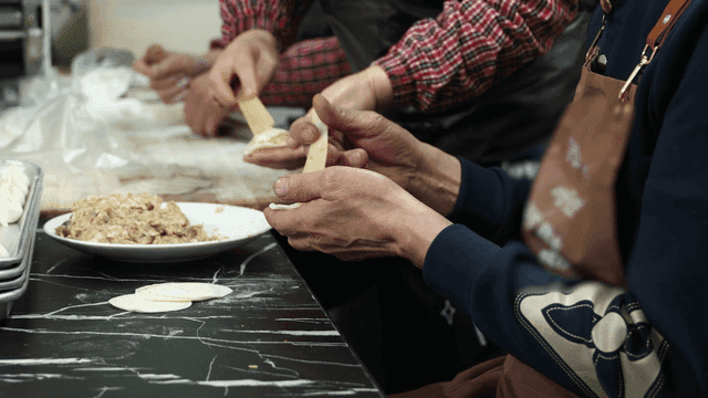 People who make dumplings by filling them