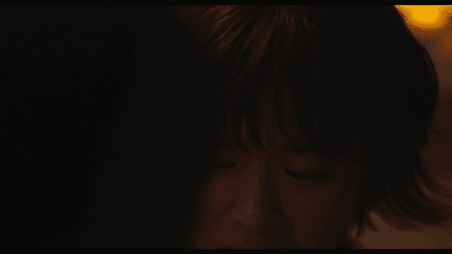Woman looking worried in dim light