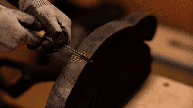 장인이 정교하게 나무를 조각하는 모습