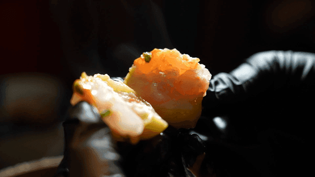 Shrimp dim sum eaten by gloved hands