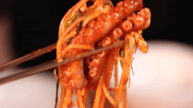 Octopus seafood stew picked up with chopsticks