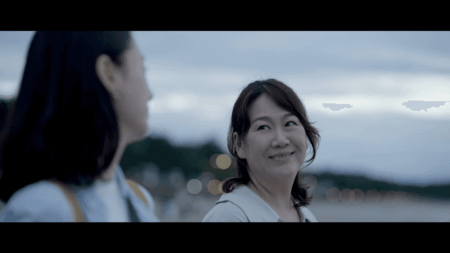 Two women smiling at each other