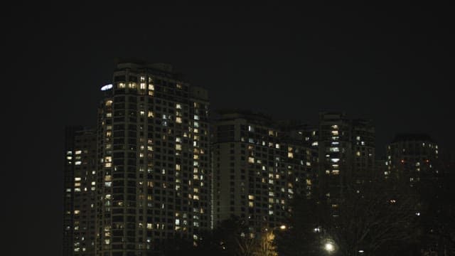 Illuminated High Apartment Buildings at Night