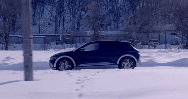 Car driving through a snowy landscape