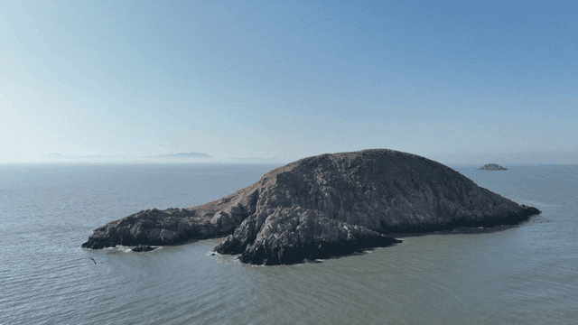 Rocky island surrounded by calm sea