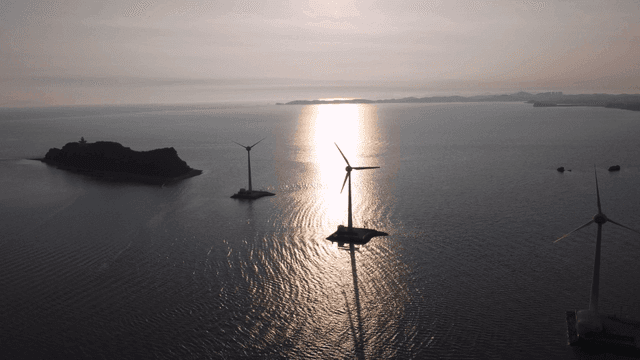 Wind turbines on sunlit sea