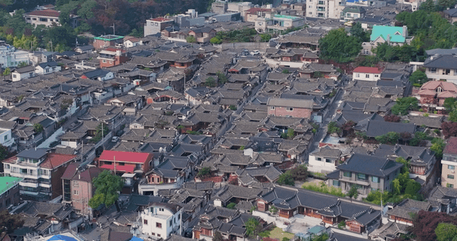 Panoramic view of a Hanok village lined with traditional tiled roofs