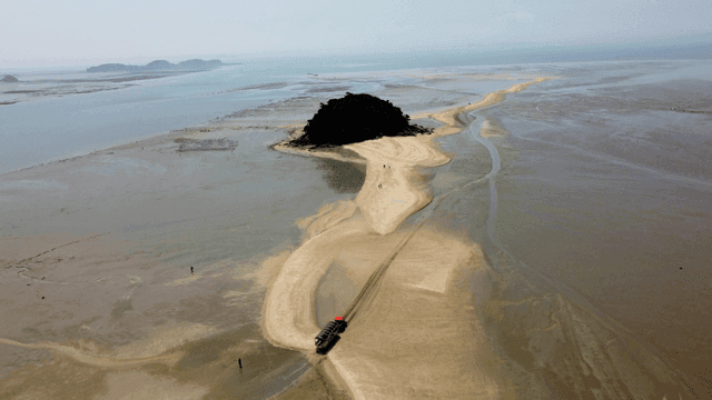 Sandy path leading to small island