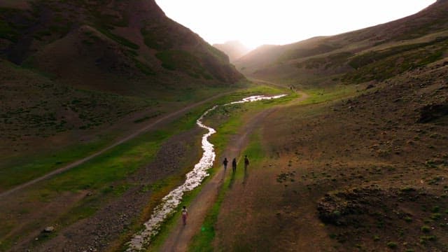 People walking along a mountain path