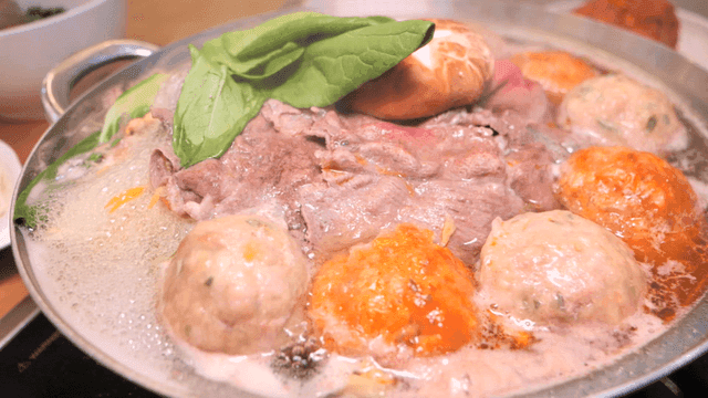 Rolled dumpling hot pot simmering on table