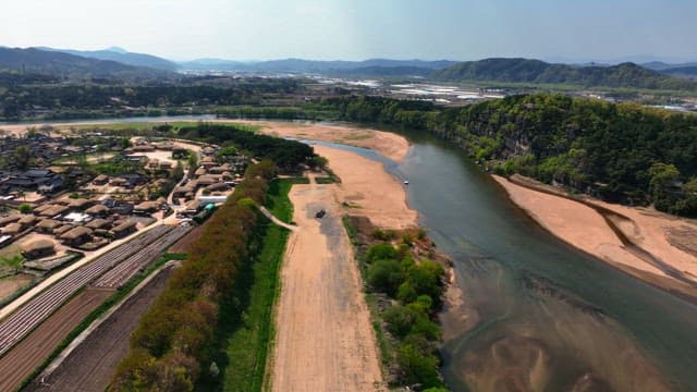 Tranquil river by traditional Korean house village