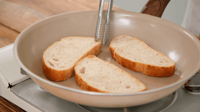 Slices of bread being toasted in a pan
