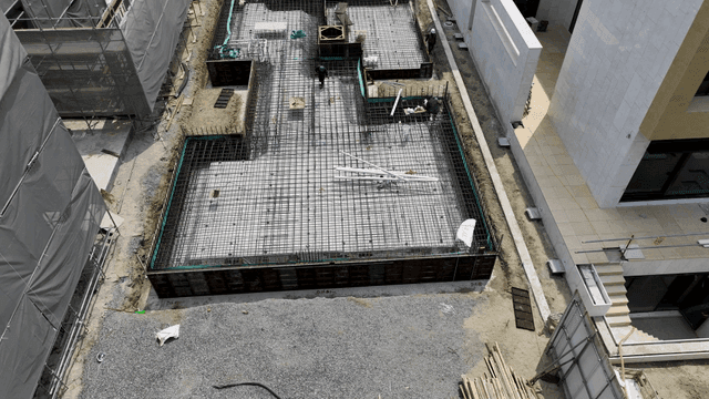 Construction site with workers and buildings