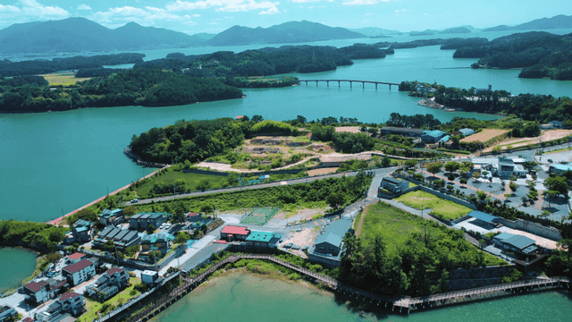 A scenic coastal village with lush greenery