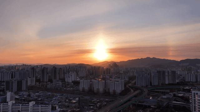 Sunset over a sprawling city skyline