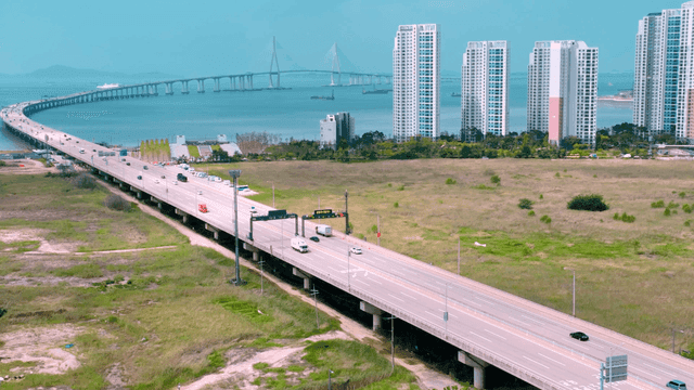 City highway leading to bridge next to sea