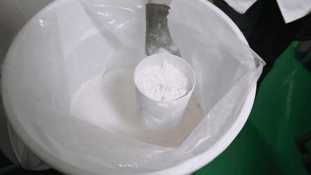 Scooping flour from large container