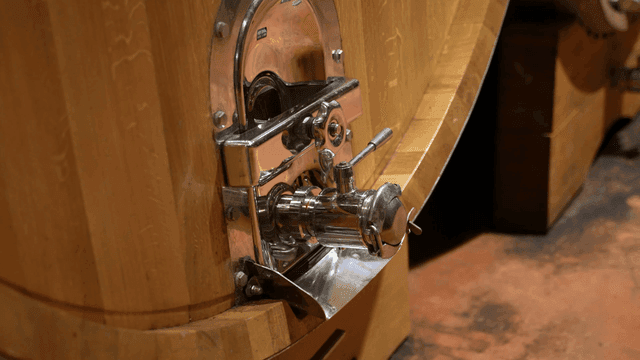 A close-up of a wine barrel tap
