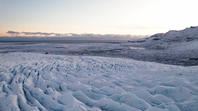 Vast glacier with snowy mountains