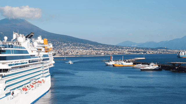 Cruise ships docked with a mountain view