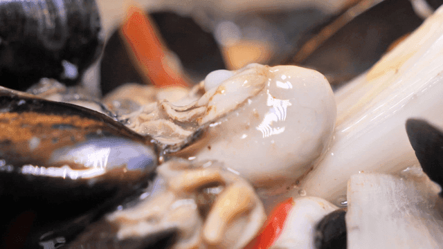 Fresh oysters with hot broth poured over them