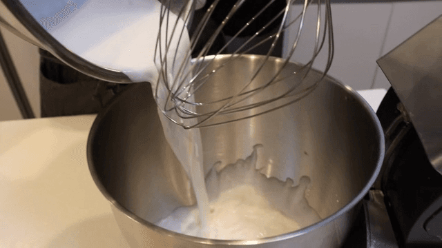 Adding fresh cream to a mixing bowl