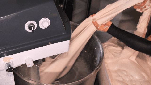 Process of removing dough from large mixer