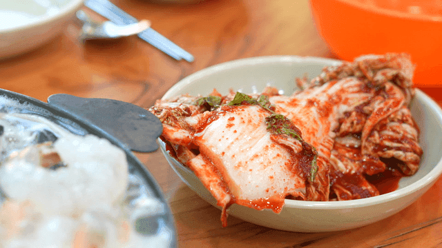 Seafood stew and kimchi on a table