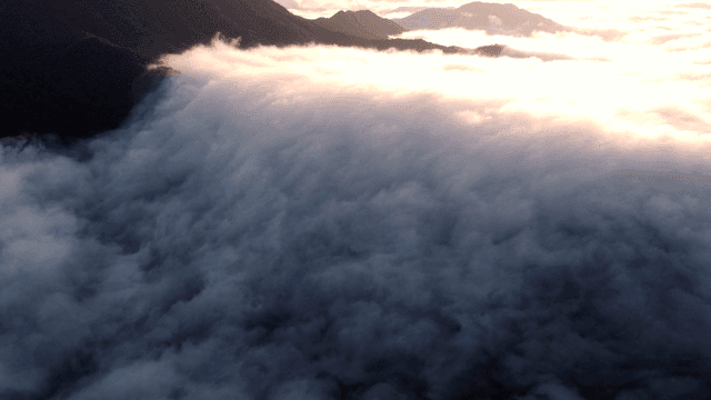 Clouds rolling over mountain peaks