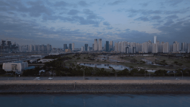 City skyline with sea and road