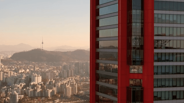 Cityscape with a red skyscraper and tower