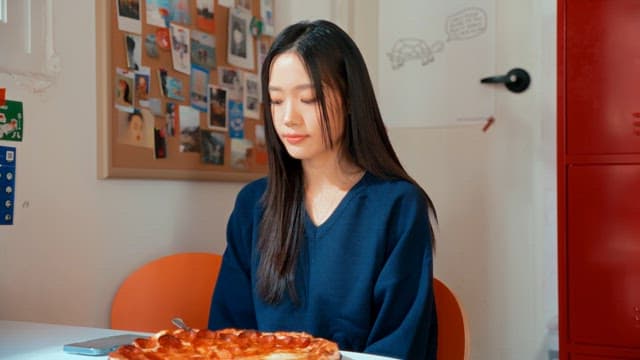 Woman taking photos of a pizza indoors