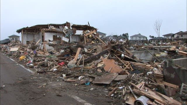 Collapsed houses and debris in a village swept away by the tsunami