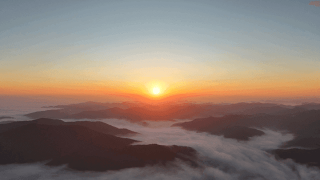 Sunrise over misty mountains