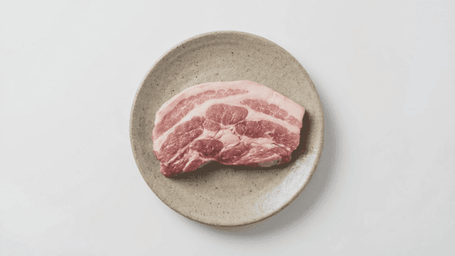 Piece of raw pork belly on plate
