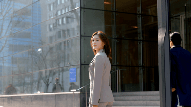 Female office worker standing in front of company