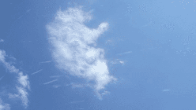 Clear blue sky with scattered clouds