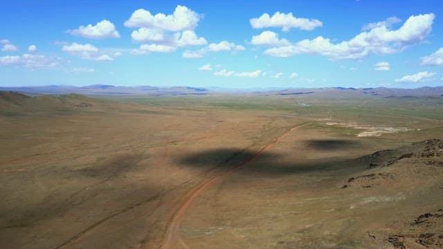 Vast open plains with distant mountains