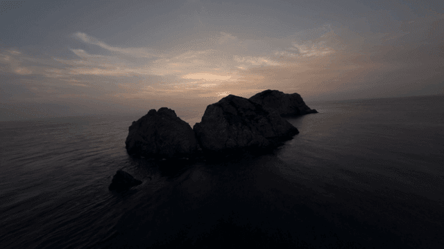 Sunset over rocky coastline and sea