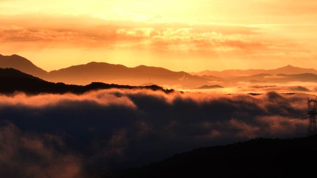 Sunrise over misty mountains