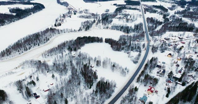 Snow-covered village and winding road