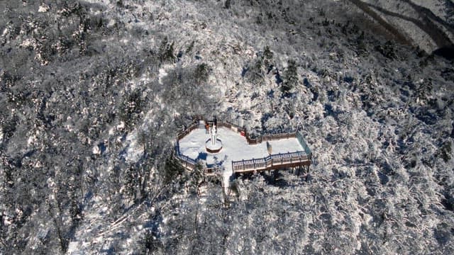 Observation deck on top of a white snow-covered mountain