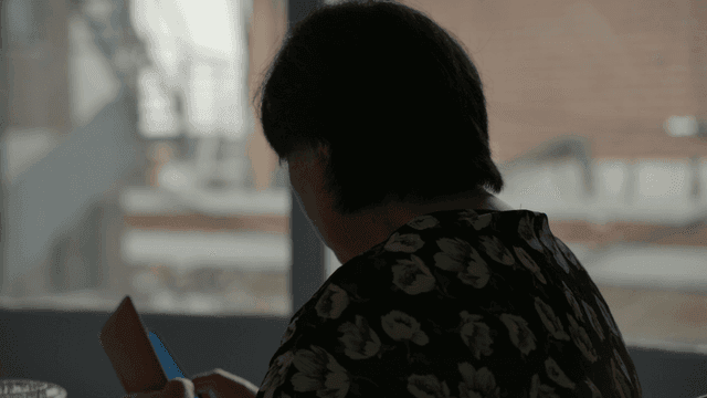 A person using a smarphone indoors