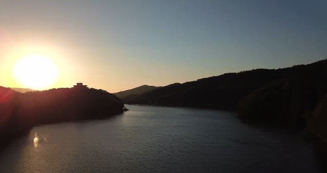 Sunset over a serene lake with mountains